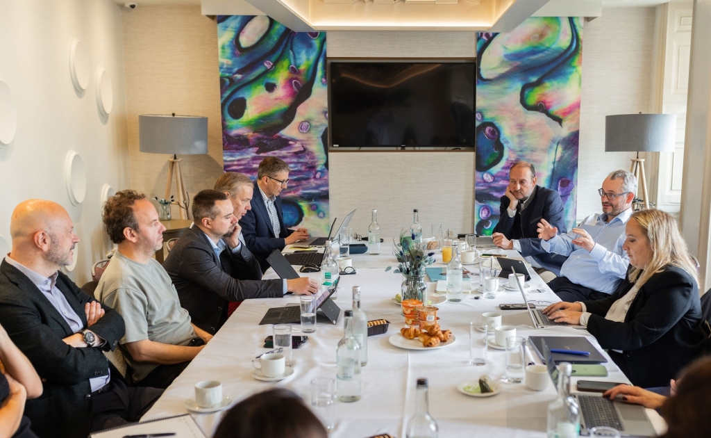 Meeting attendees in discussion at a round table